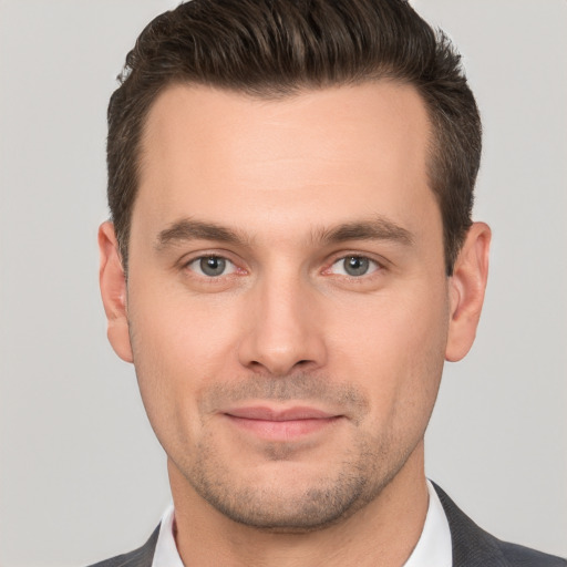 Joyful white young-adult male with short  brown hair and brown eyes