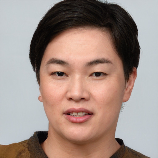 Joyful asian young-adult female with short  brown hair and brown eyes
