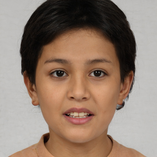 Joyful asian child female with short  brown hair and brown eyes