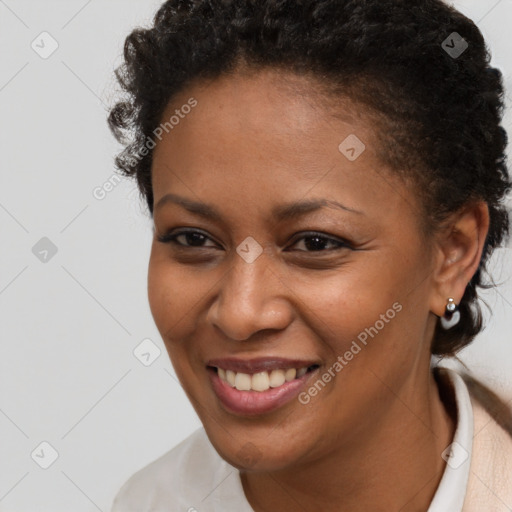 Joyful black young-adult female with short  brown hair and brown eyes