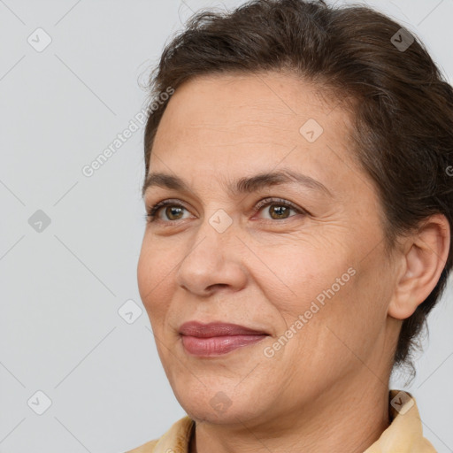 Joyful white adult female with medium  brown hair and brown eyes