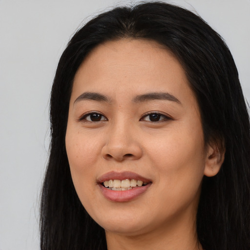 Joyful asian young-adult female with long  black hair and brown eyes