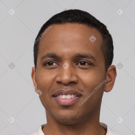 Joyful black young-adult male with short  black hair and brown eyes