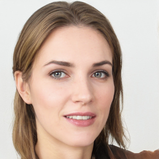 Joyful white young-adult female with long  brown hair and grey eyes