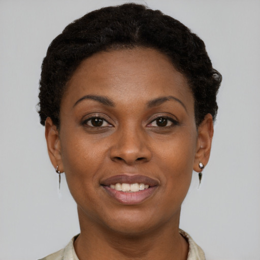 Joyful black young-adult female with short  brown hair and brown eyes
