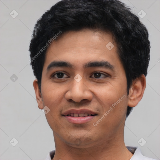 Joyful latino young-adult male with short  black hair and brown eyes