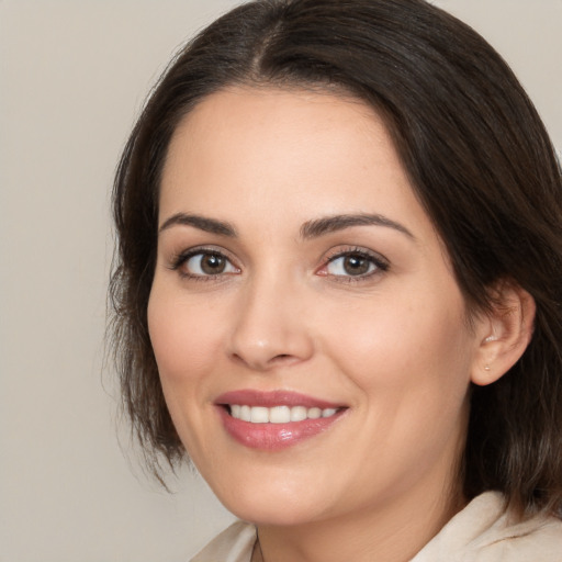 Joyful white young-adult female with medium  brown hair and brown eyes