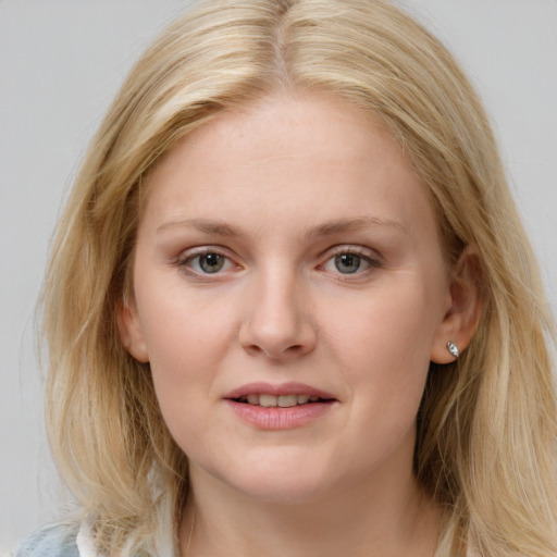 Joyful white young-adult female with long  brown hair and blue eyes