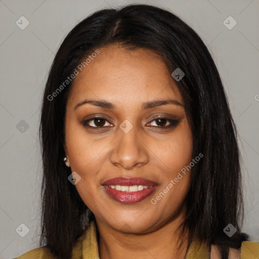 Joyful black young-adult female with long  black hair and brown eyes