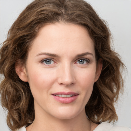 Joyful white young-adult female with medium  brown hair and green eyes