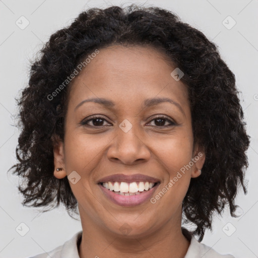 Joyful black adult female with medium  brown hair and brown eyes