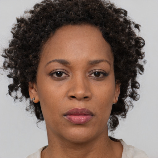 Neutral black adult female with medium  brown hair and brown eyes