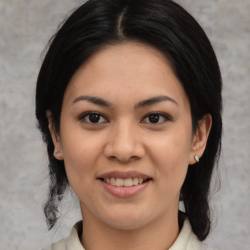 Joyful asian young-adult female with medium  black hair and brown eyes