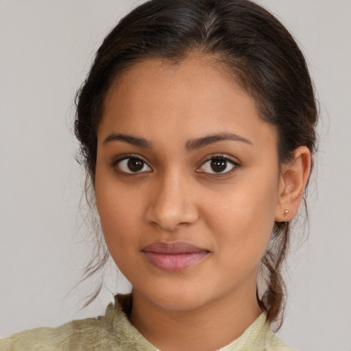 Joyful latino young-adult female with medium  brown hair and brown eyes