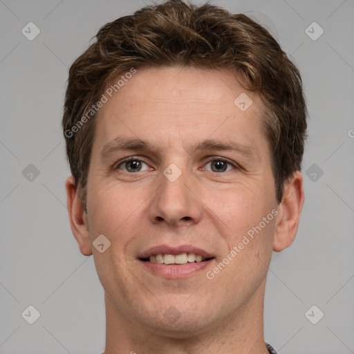 Joyful white adult male with short  brown hair and grey eyes