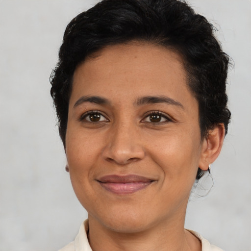 Joyful latino young-adult female with short  brown hair and brown eyes