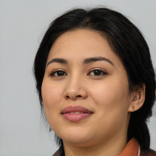 Joyful asian young-adult female with long  black hair and brown eyes
