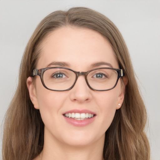 Joyful white young-adult female with long  brown hair and blue eyes