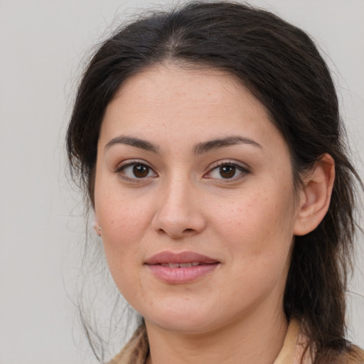 Joyful white young-adult female with medium  brown hair and brown eyes