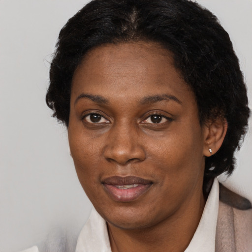 Joyful black adult female with short  brown hair and brown eyes