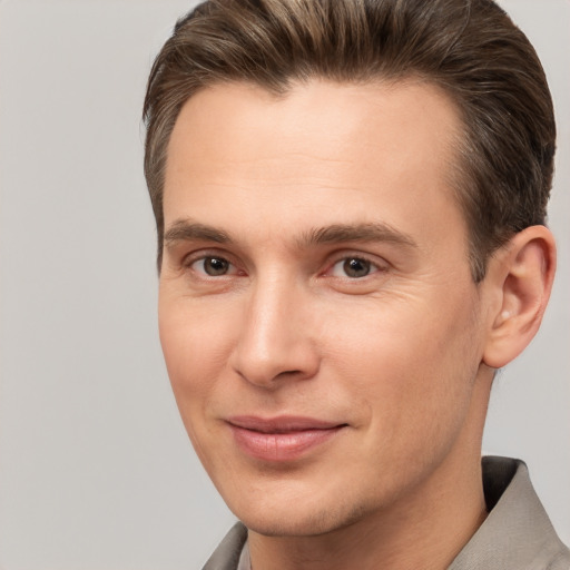 Joyful white young-adult male with short  brown hair and brown eyes