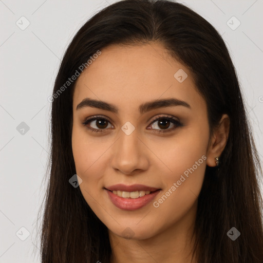 Joyful latino young-adult female with long  brown hair and brown eyes