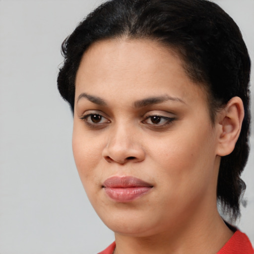 Joyful black young-adult female with medium  brown hair and brown eyes