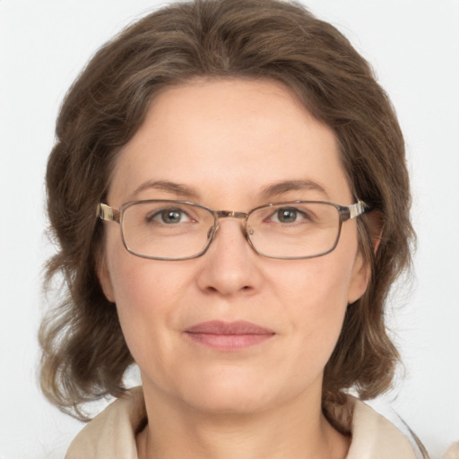 Joyful white adult female with medium  brown hair and green eyes