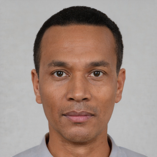 Neutral black adult male with short  black hair and brown eyes