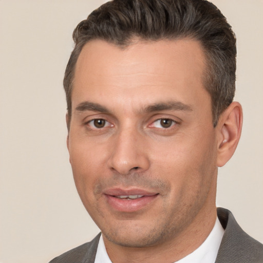 Joyful white adult male with short  brown hair and brown eyes