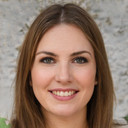 Joyful white young-adult female with long  brown hair and green eyes