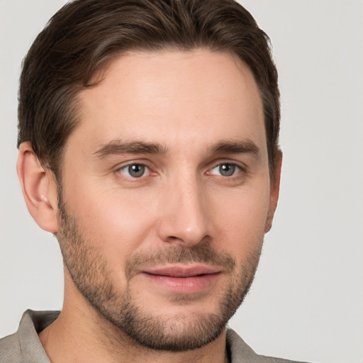 Joyful white young-adult male with short  brown hair and brown eyes