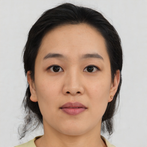Joyful asian young-adult female with medium  black hair and brown eyes