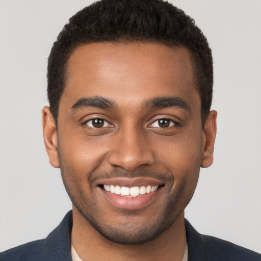 Joyful black young-adult male with short  brown hair and brown eyes