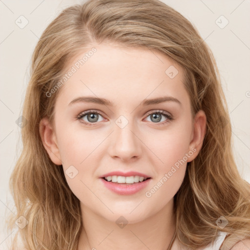 Joyful white young-adult female with long  brown hair and blue eyes