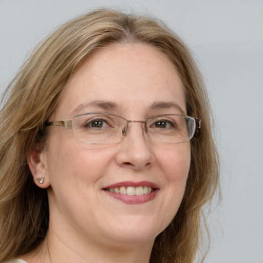 Joyful white adult female with long  brown hair and blue eyes