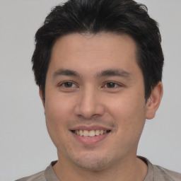 Joyful asian young-adult male with short  brown hair and brown eyes