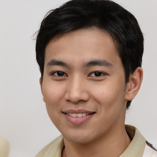 Joyful asian young-adult male with short  black hair and brown eyes