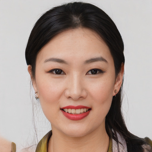 Joyful asian young-adult female with medium  brown hair and brown eyes