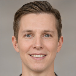 Joyful white adult male with short  brown hair and grey eyes