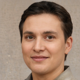 Joyful white adult male with short  brown hair and brown eyes