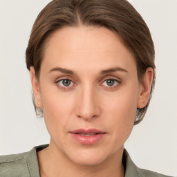 Joyful white young-adult female with medium  brown hair and grey eyes