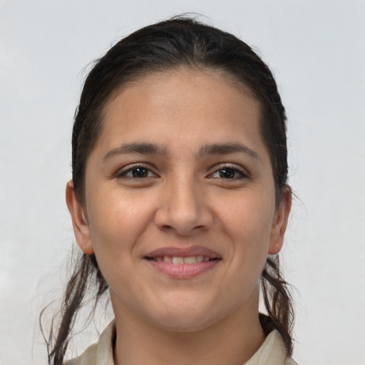 Joyful white young-adult female with long  brown hair and brown eyes