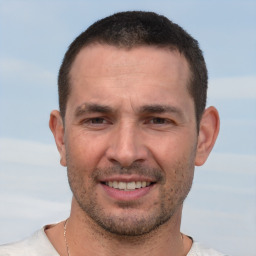 Joyful white adult male with short  brown hair and brown eyes