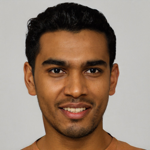 Joyful latino young-adult male with short  black hair and brown eyes