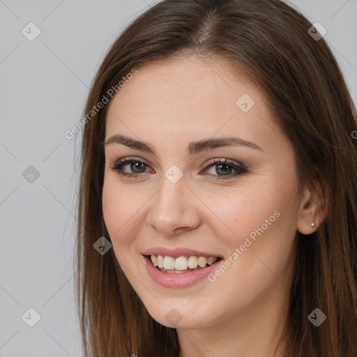 Joyful white young-adult female with long  brown hair and brown eyes