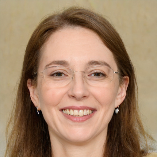 Joyful white adult female with long  brown hair and grey eyes