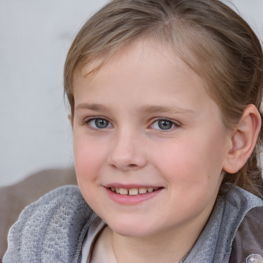 Joyful white child female with medium  brown hair and grey eyes