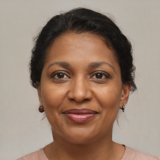 Joyful black adult female with medium  brown hair and brown eyes