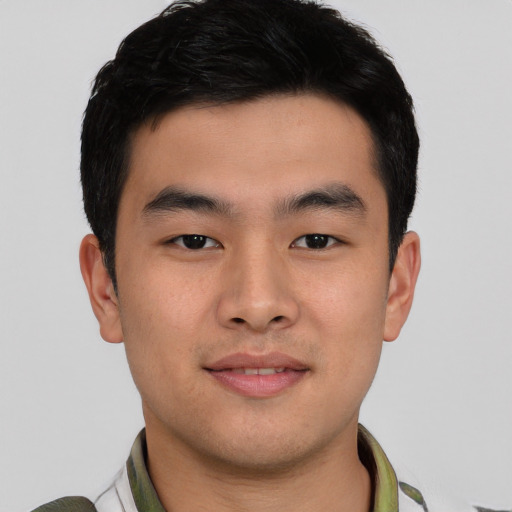 Joyful asian young-adult male with short  black hair and brown eyes